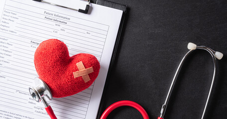 Top view of stethoscope and red heart for cholesterol diet and diabetes control on pastel blue...