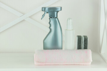 Cleaning concept. Detergents in spray. Сleaning accessories. Stack of cleaning sponges and bottle with a cleaning.