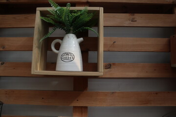 wooden shelf with teapot and green plants design for gardening decoration