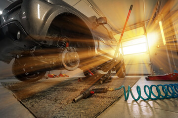 Car servise lifting car and changing wheels. A spring hose to a pneumatic tool. Tire repair, wheel...