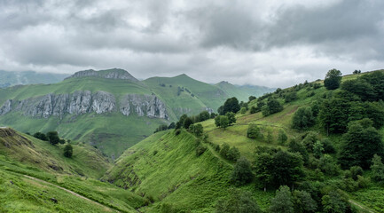 Fototapeta na wymiar Rough mountain landscape with steep limestone slopes and green meadows