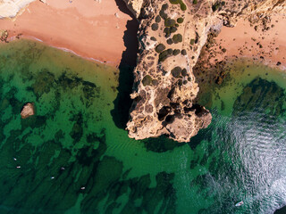 Aerial photos of Algarve Coast in Faro, Portugal capture the region's stunning beaches, rugged cliffs, and charming towns from a unique perspective, offering breathtaking views of the natural beauty