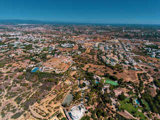 Aerial photos of Algarve Coast in Faro, Portugal capture the region's stunning beaches, rugged cliffs, and charming towns from a unique perspective, offering breathtaking views of the natural beauty