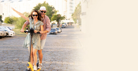 Happy young couple in love on vacation having fun, driving electric scooter through the city. Eco transport © opolja