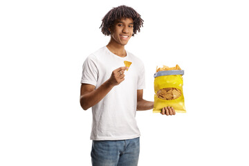 Young african american man eating tortilla crisps and smiling