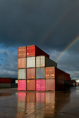 A stack of shipping containers on a deserted dock