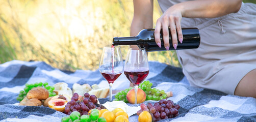 picnic in nature, girl pouring wine, couple in love. nature.