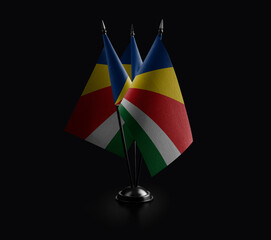 Small national flags of the Seychelles on a black background