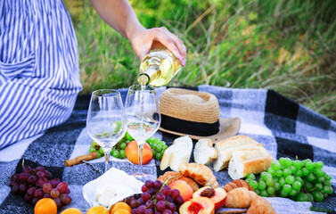picnic in nature, girl pouring wine, couple in love. nature.