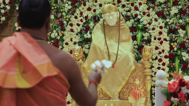 Closeup video of the Sai Ram or Sai Baba idol being worshipped with arti