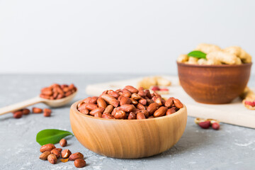 Fresh healthy peanuts in bowl on colored table background. Top view Healthy eating bertholletia concept. Super foods