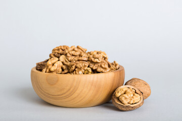 Fresh healthy walnuts in bowl on colored table background. Top view Healthy eating bertholletia concept. Super foods