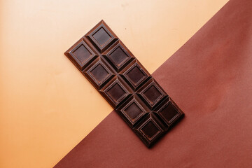 a whole bar of dark chocolate on a two-tone background