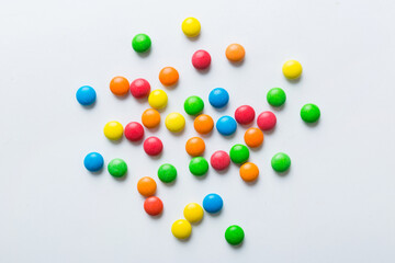 Mixed collection of colorful candy, on colored background. Flat lay, top view. frame of colorful chocolate coated candy