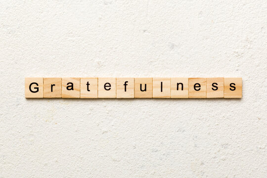 gratefulness word written on wood block. gratefulness text on cement table for your desing, concept