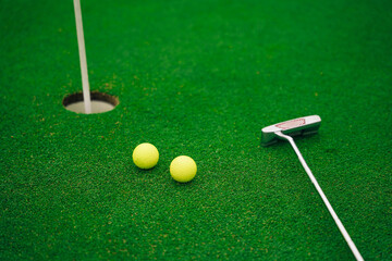 Equipment for playing golf. golf ball on lip of cup