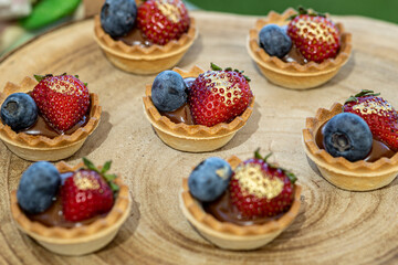 Colorful and elegant sweet canapés, made with cranberry and strawberry and topped with whipped cream, perfect for a festive occasion celebration