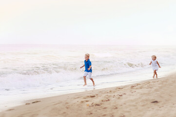 Happy kids running on the beach
