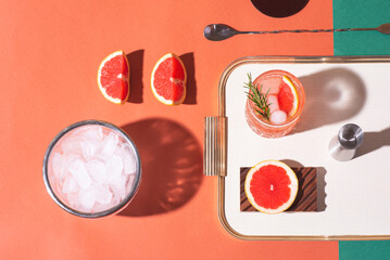Red cocktail in base of Campari or bitter with blood red oranges (tarocco) on the geometric ...