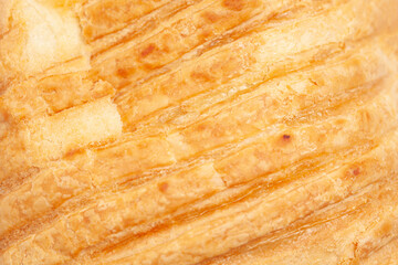 Close-up fragment of a puff pastry as a backdrop texture composition.