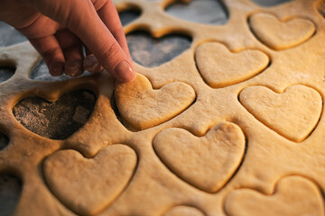 cooking heart shaped cookies in dough closeup