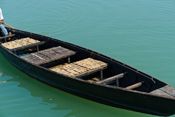wooden boat floating in the river water
