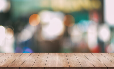 Empty wooden table top with lights bokeh on blur restaurant background.	
