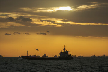 Ships waiting in the Marmara Sea to pass through the İstanbul Bosphorus. cloudy sunset. backlight.