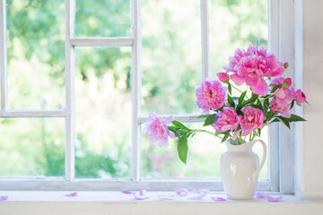 pink peony in vase on grunge white interior