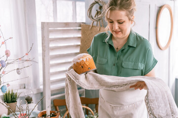 happy easter holiday time in spring season. beautiful young housewife woman holds a freshly baked...