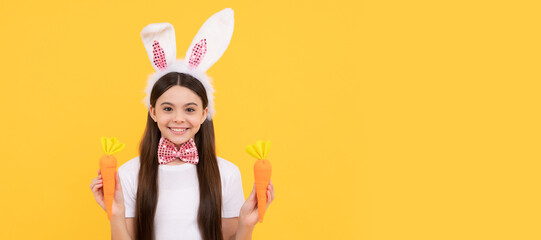 childhood happiness. child in rabbit ears and bow tie. time for fun. kid looking funny with carrot. Easter child horizontal poster. Web banner header of bunny kid, copy space.