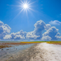 small saline lake under a sparkle sun