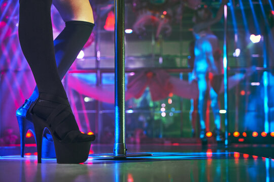 Young sexy girl in strip club luring visitors to the lap dance. striptease