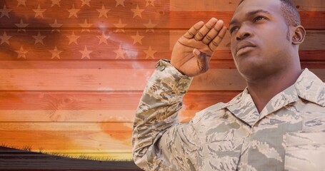 Digital composite image of young african american military man saluting against america flag