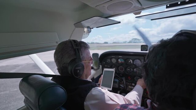 Pilot doing preflight checklist before take off at the airport. Caracas, Venezuela