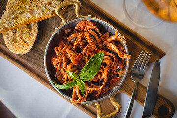 Gourmet dish of small octopuses with spicy sauce.