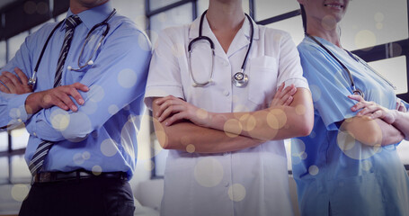 Image of caucasian doctors over spots