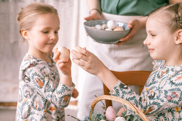 easter holiday time in spring season. happy family candid little kids sisters girls together mother...