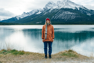 girl standing to the viewer among the mountains banff, canada