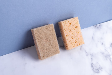 Sponges for washing dishes made of sisal. Two sponges on blue background. Double-sided sponges