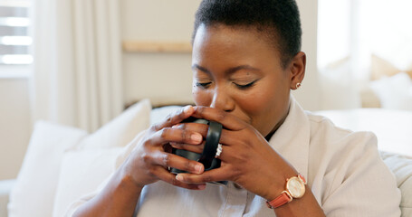 Black woman, coffee and relax watching tv on sofa drinking espresso in living room home. Tea, happy...