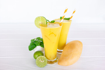 Mango smoothies yellow colorful fruit juice milkshake blend beverage healthy high protein the taste yummy In glass,drink to lose weight drink episode morning on white gray background.