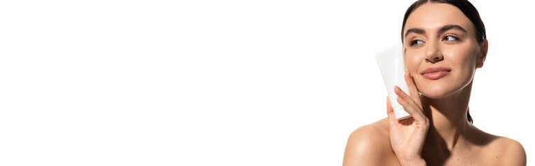 happy young woman with bare shoulders holding tube with body lotion isolated on white, banner.