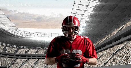 Composite image of male rugby player holding a rugby ball against sports stadium