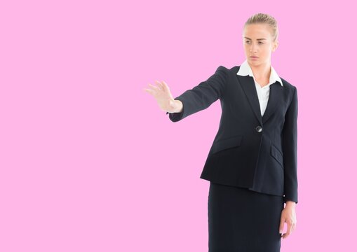 Caucasian businesswoman holding an invisible object against copy space on pink background - Powered by Adobe
