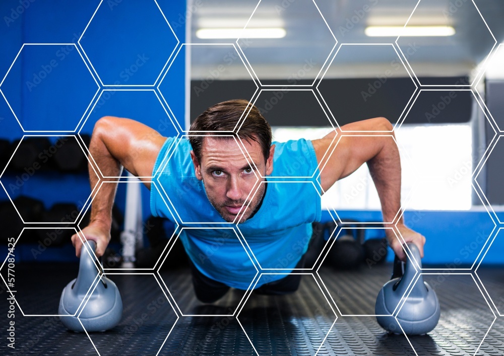 Poster hexagonal shapes pattern design against caucasian fit man performing push up exercise with dumbbells