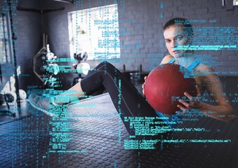 Data processing against caucasian fit woman working out with medicine ball at the gym