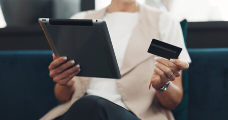 Woman, tablet and credit card for ecommerce, online shopping and paying bills while on a couch reading details or information for payment. Hands of female doing online banking with wifi network
