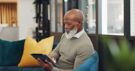 Tablet, technology and senior black man on sofa browse online website, social media and internet. Online shopping, retirement and elderly male enjoy freedom, weekend and relax with digital tech