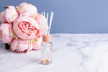 Aroma diffuser for home with sticks. Space for text. Aroma diffuser and bouquet of flowers